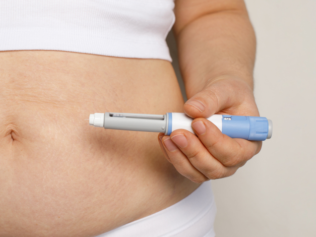 Woman hand with semaglutide injection pen or insulin cartridge pen for diabetics and weight loss. Medical equipment for diabetes patient